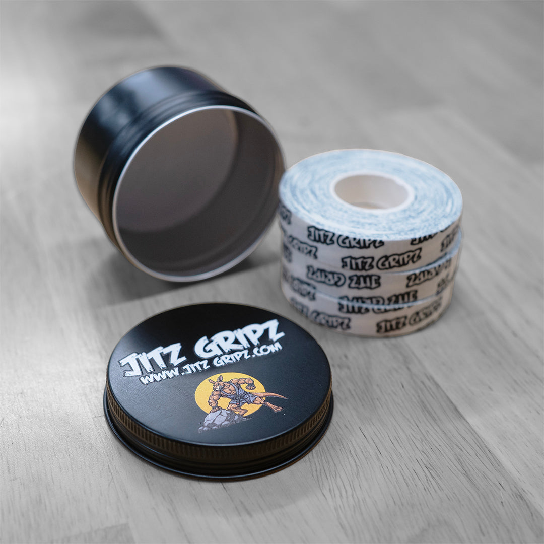 JitzGripz BJJ finger tape 3-roll tin open showing premium cotton tape rolls