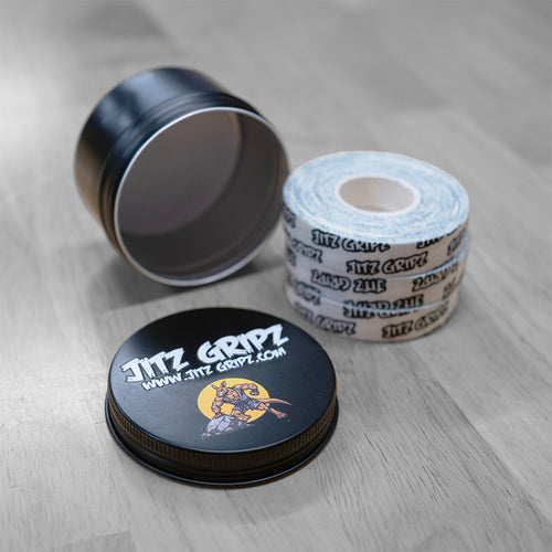 JitzGripz BJJ finger tape 3-roll tin open showing premium cotton tape rolls