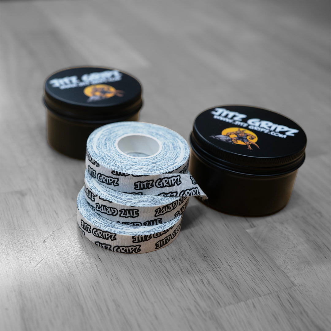 Stacked rolls of JitzGripz BJJ finger tape showing durable woven cotton
